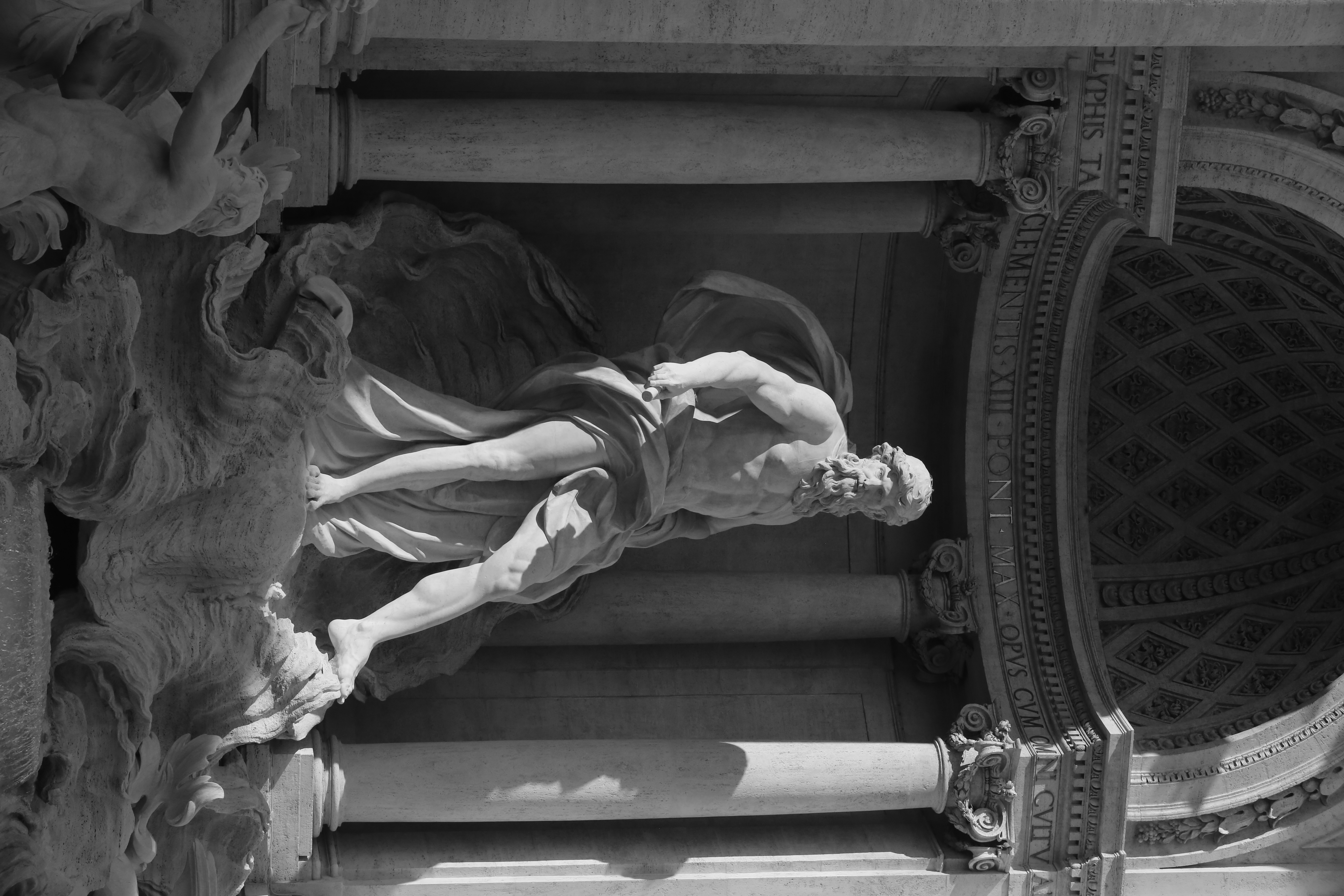 Full-length marble statue of a bearded figure stepping forward, framed by classical columns